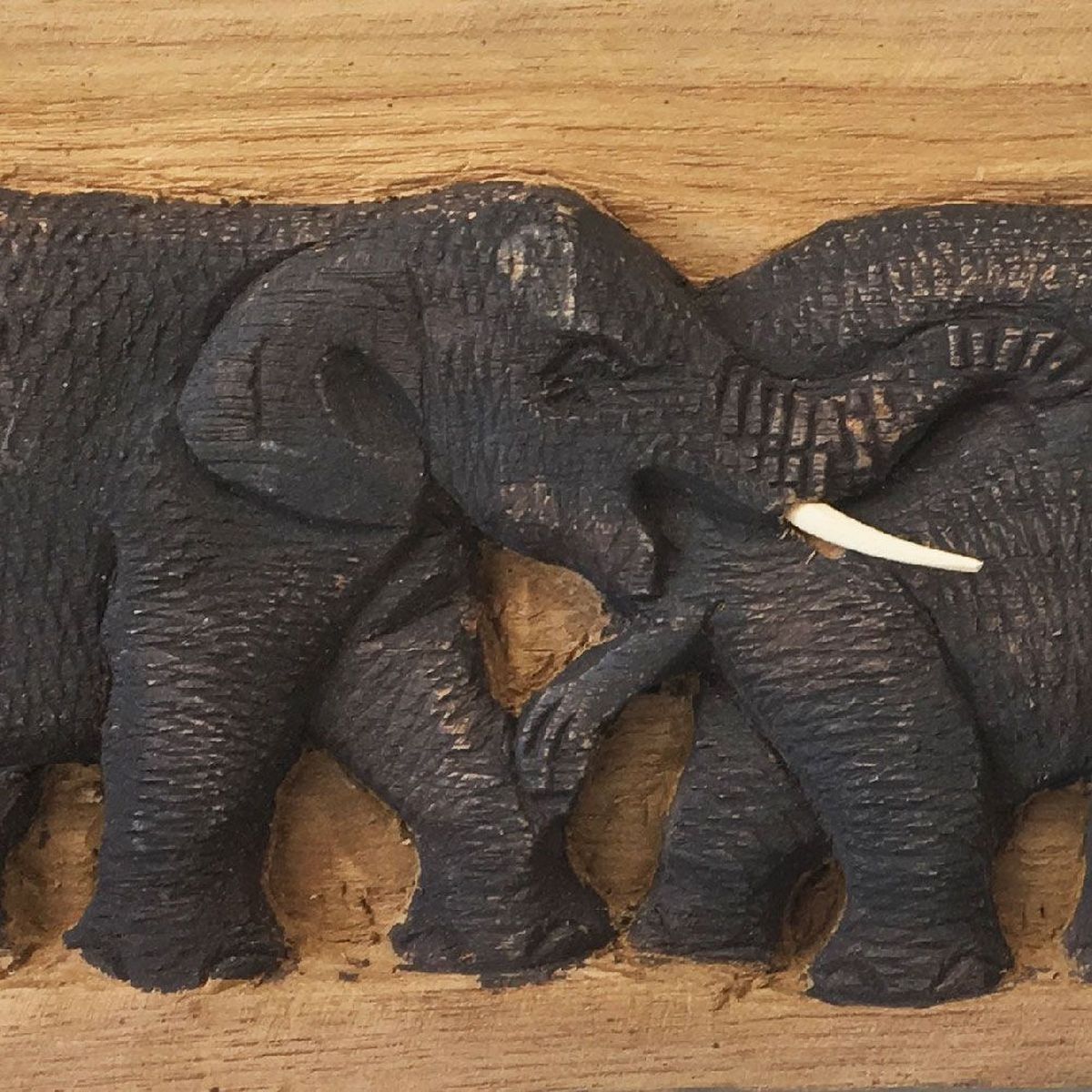 Basrelief panel of elephants carved on raw wood 45 X 15 cm